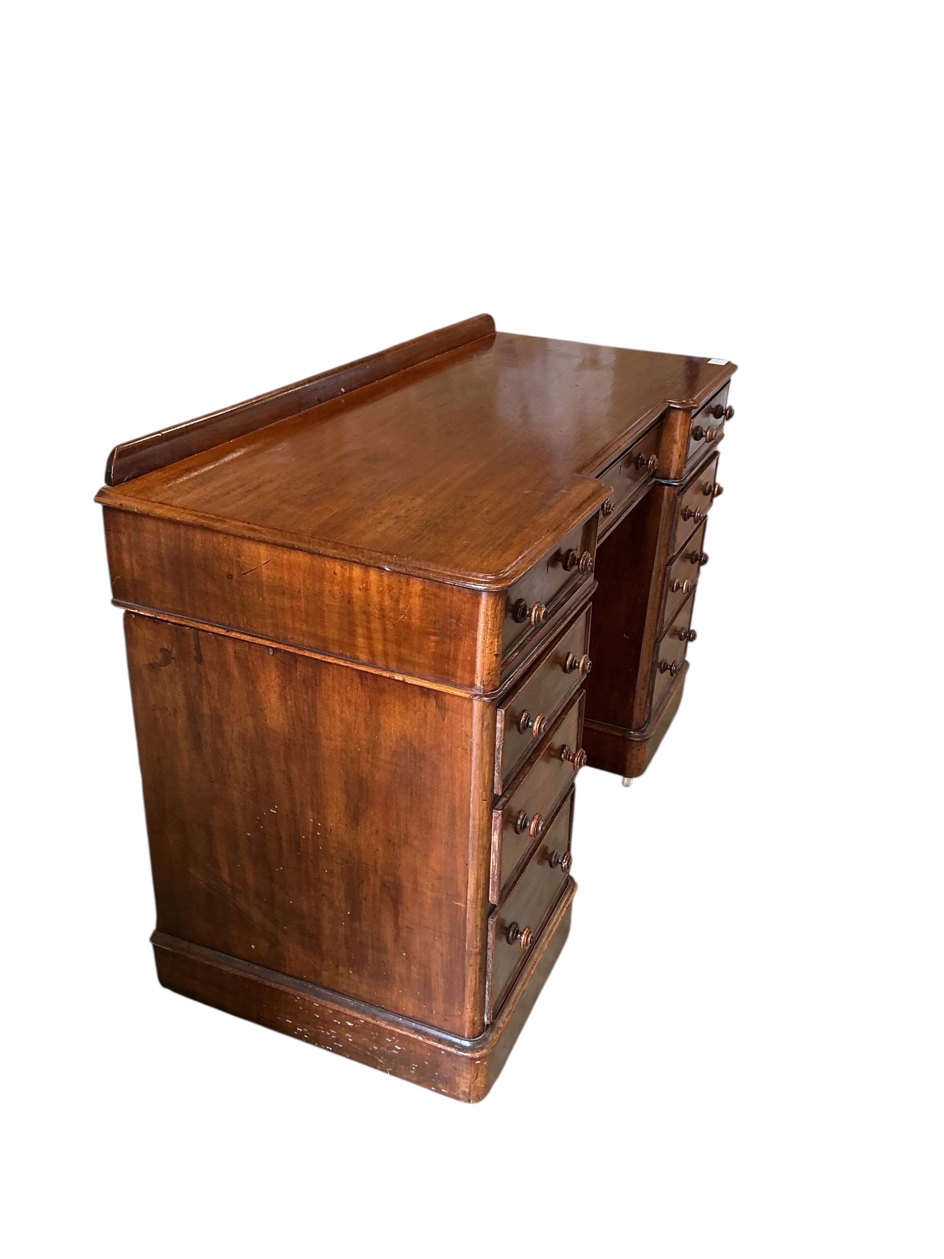 A Victorian mahogany inverse breakfront pedestal dressing table, width 120cm, depth 52cm, height 80cm